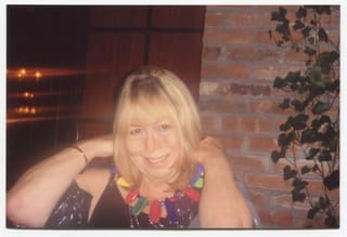 Cynthia wearing multicoloured necklace.