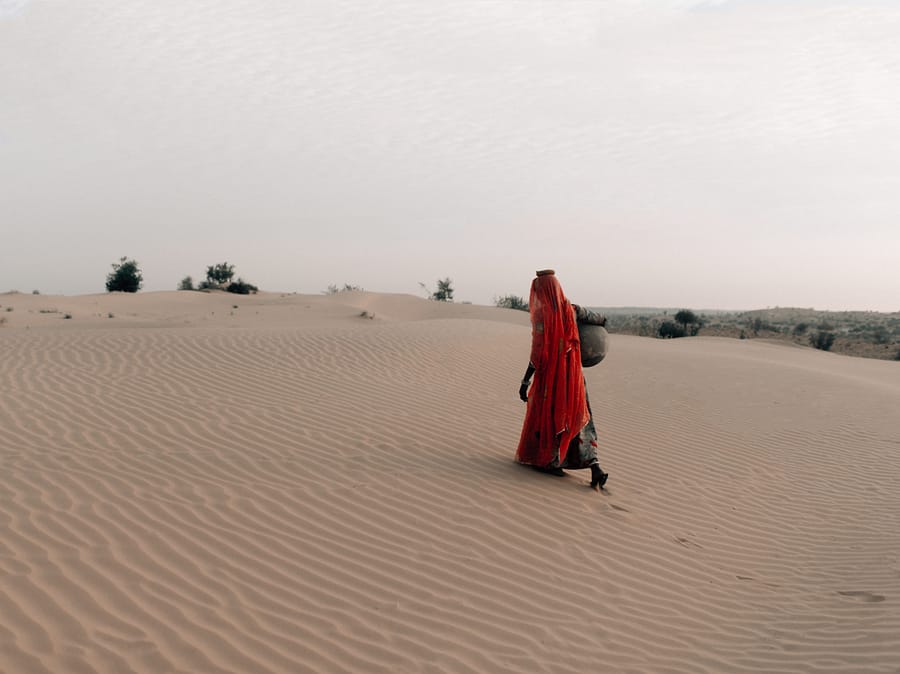 charity water India campaign walking in sand photo